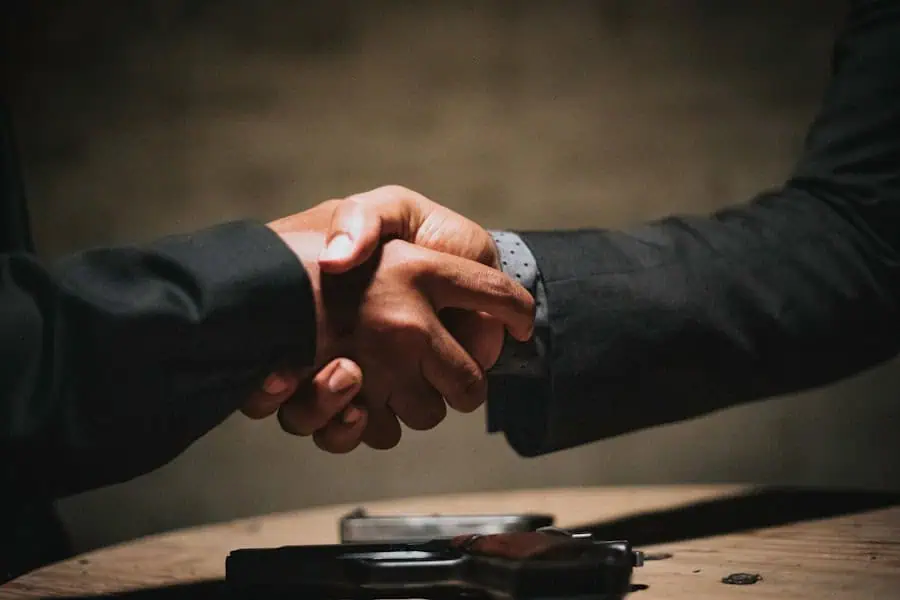 The significance of M&A transactions | CAFM-Blog.de Handshake between business partners, symbolises cooperation and trust.